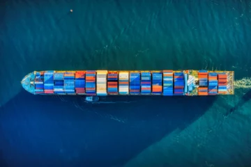 Photo of a boat with shipping containers by Venti Views on Unsplash.com